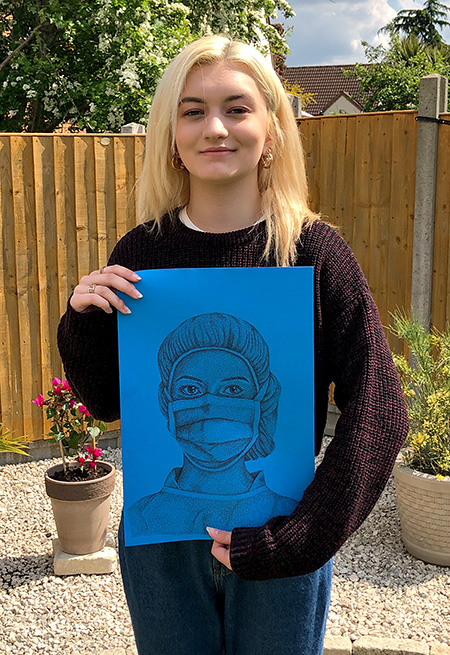Photo of Jess holding her drawing.