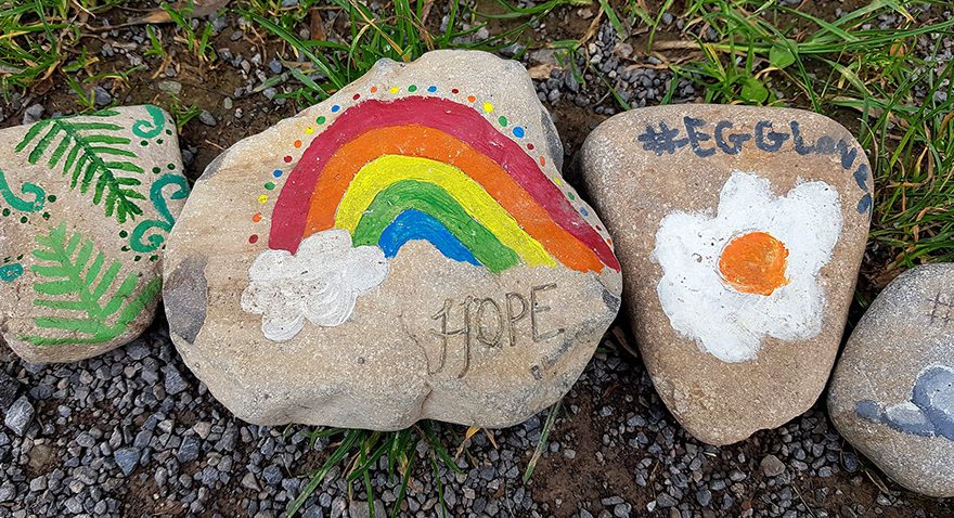 Photo showing three colourfully painted stones in the body of the 'happiness snake'.