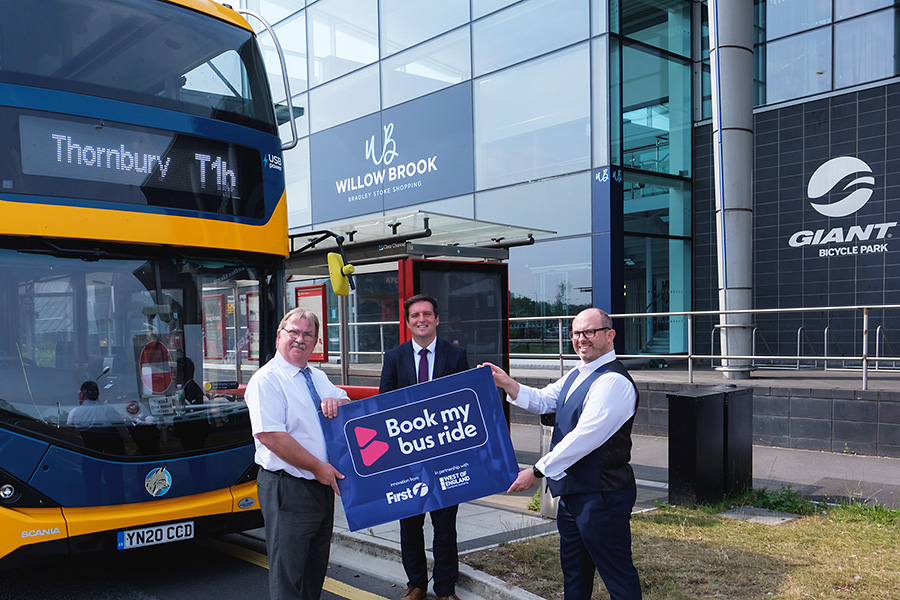 Photo of the 'Book my bus ride' service being launched outside the Willow Brook shopping centre.