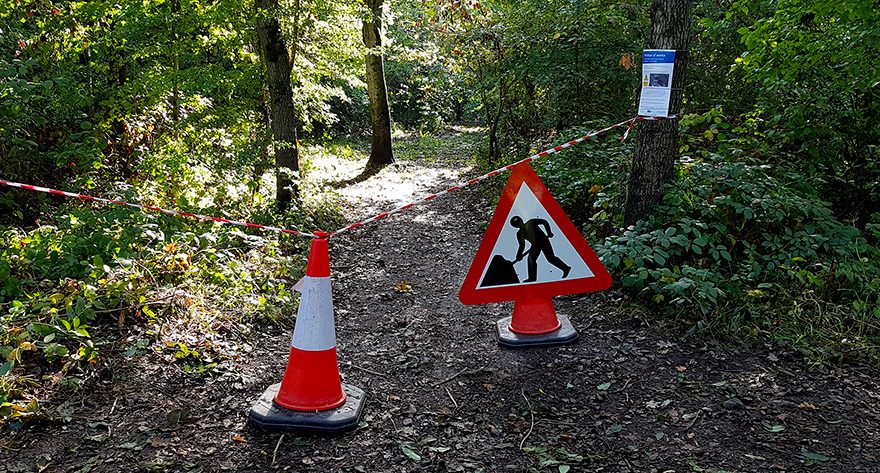Photo of a taped-off path with a roadworks sign.