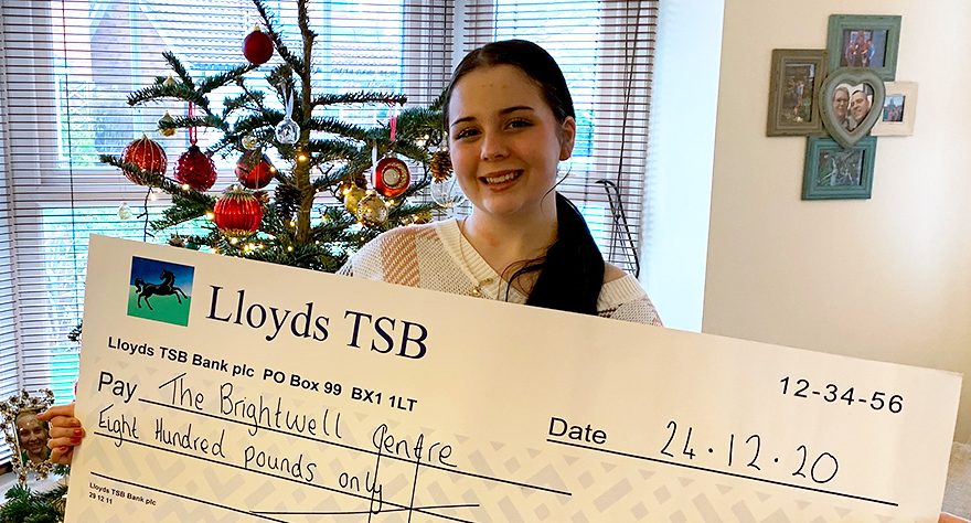 Photo of Pearl Bruford with a presentation cheque.