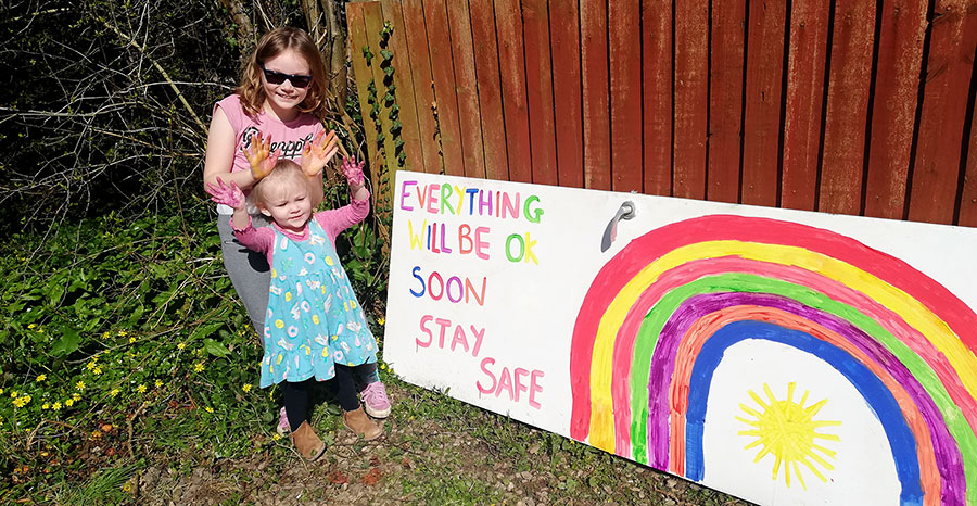 Photo of children with a rainbow banner.