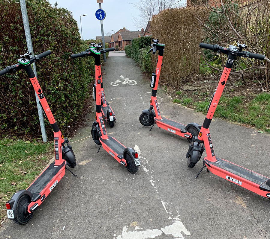 Photo of Voi e-scooters blocking a path.