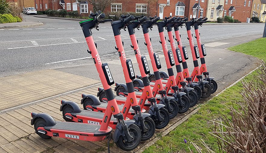 Photo of a row of Voi scooters.