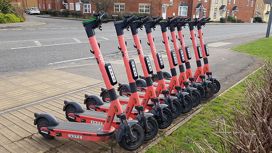 Photo of a row of Voi scooters.