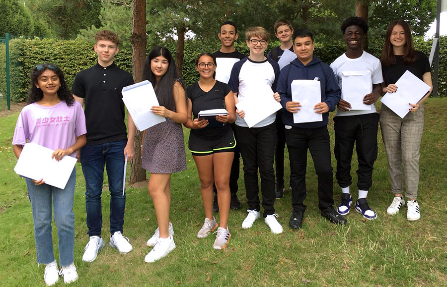 Photo of a group of students holding envelopes.
