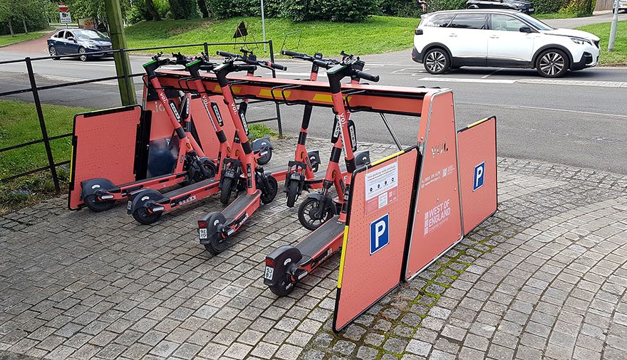 Photo of e-scooters parked in a rack.