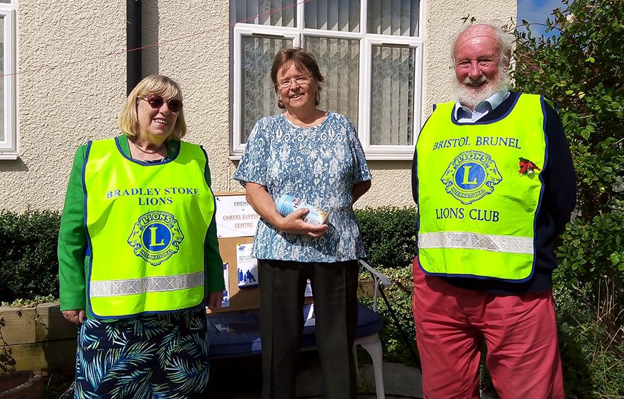 Photo of a group of three people, two wearing hi-vis tabards.