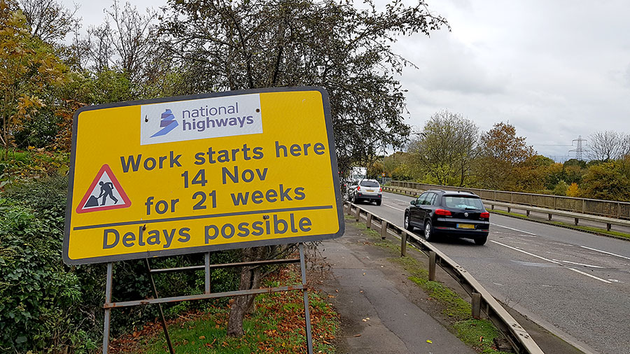 Photo of a road sign on the side of a road.