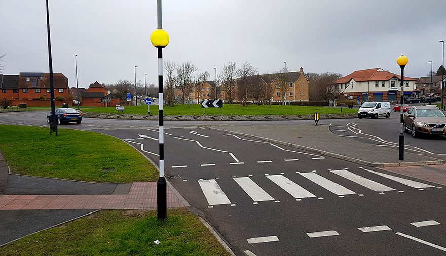 Photo of a roundabout and zebra crossing.