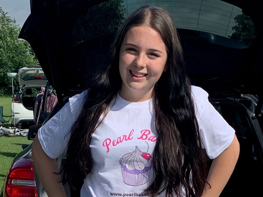 Photo of a young woman in a white t-shirt.