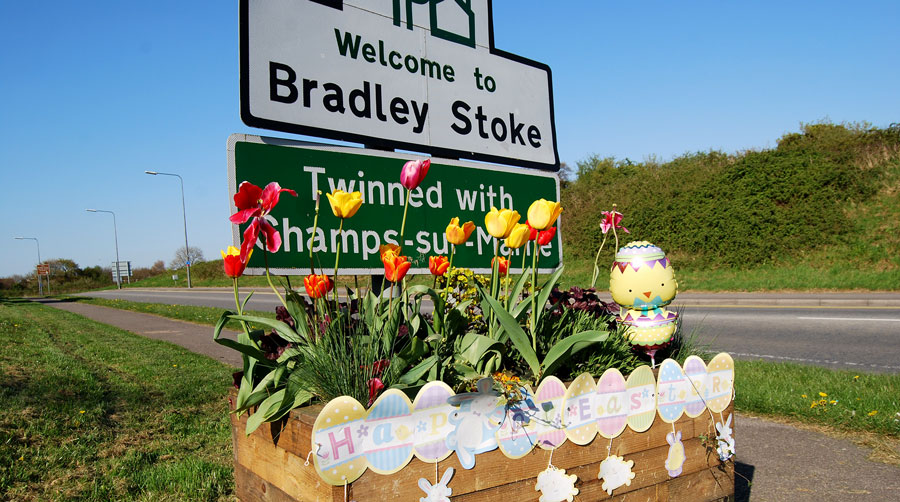 Photo of a decorated planter and sign.