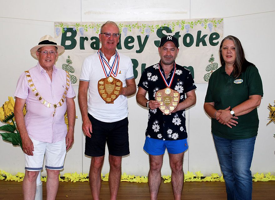 Photo of four people at a prize presentation.