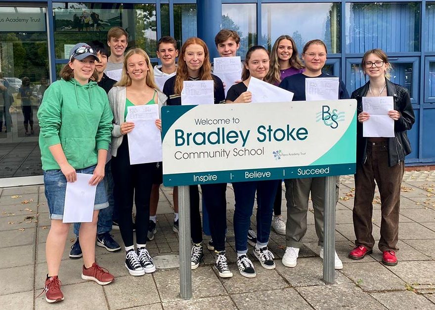 Photo of a group of students holding envelopes.