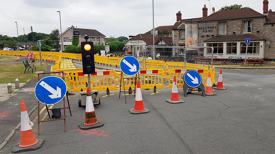 Three-way temporary traffic lights at the site of gas network roadworks in North Road, Stoke Gifford. Photo of temporary traffic lights at roadworks.