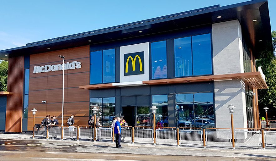 Photo of customers queuing outside a McDonald's restaurant.
