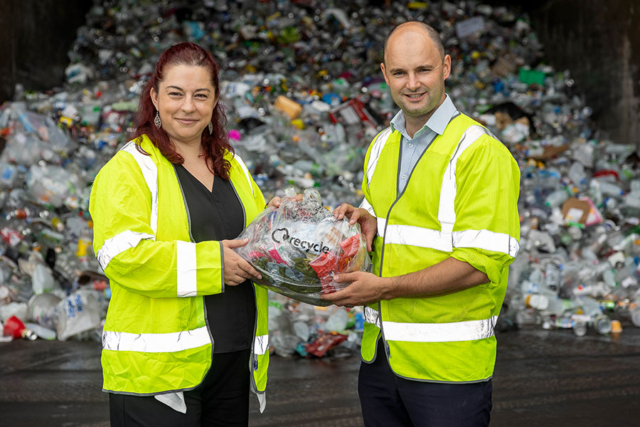 L-r: Cllr Rachael Hunt (South Gloucestershire Council) and Thornbury & Yate MP Luke Hall hold a collection bag filled with soft plastics. Photo of two people wearing hi-vis jackets and holding a plastic bag.