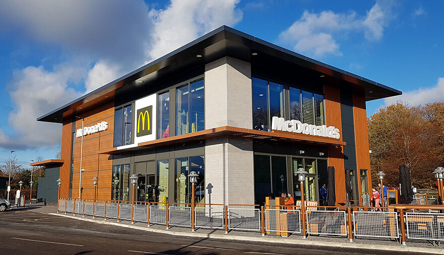 Photo of a two-storey McDonald's restaurant with drive-through.