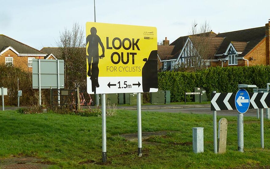 Photo of a large yellow and white sign displaying the words 'Look out for Cyclists'.