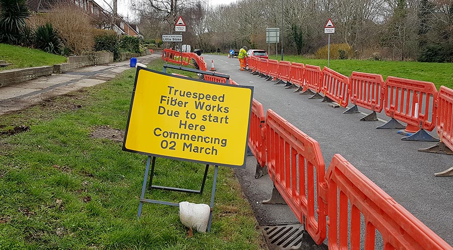 Truespeed fibre broadband network installation work in Braydon Avenue, Little Stoke, in March 2023. Photo of a yellow information sign next to some roadworks.