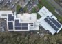 Aerial photo of a leisure centre that has solar panels on its roof.