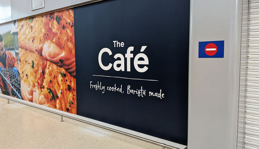Photo of a sign showing the words 'The Café'.