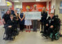 Photo of a charity cheque presentation.